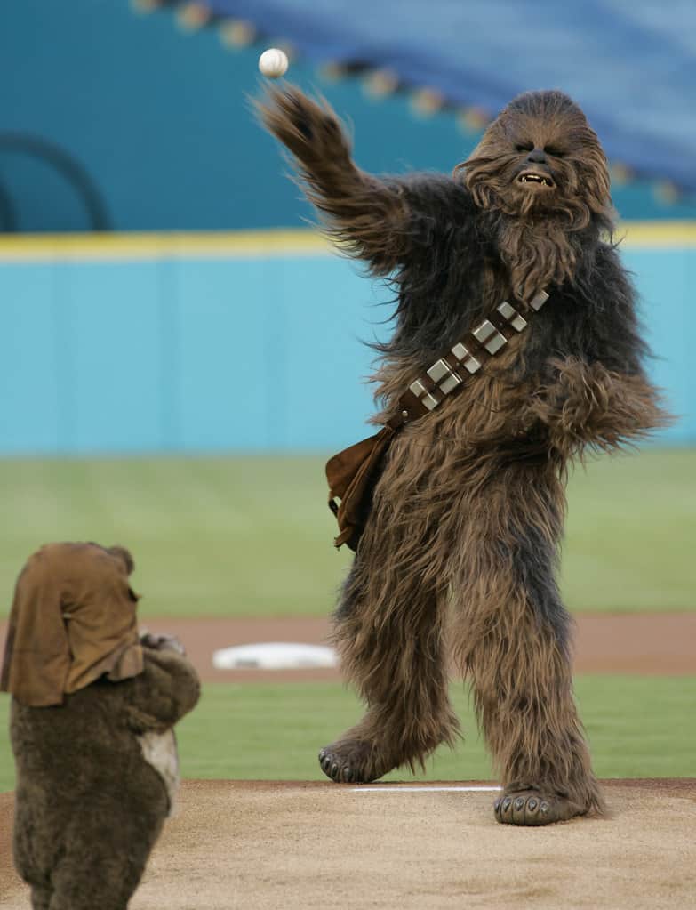 Chewbacca of Star Wars fame throws out the ceremonial first pitch as Wicket the Ewok looks on before a baseball game between the Florida Marlins and the Washington Nationals Tuesday, Aug. 22, 2006, at Dolphin Stadium in Miami. (AP Photo/Wilfredo Lee)